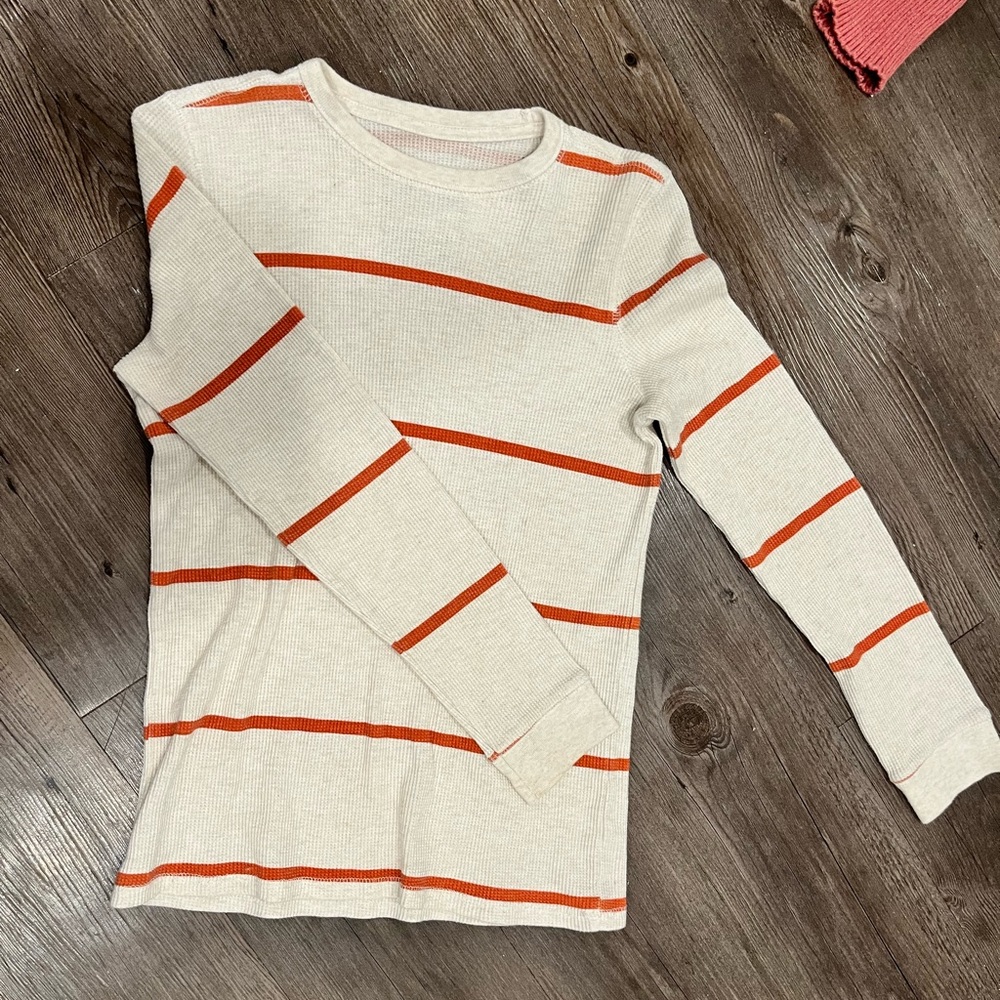 Long sleeve Orange and White striped shirt.